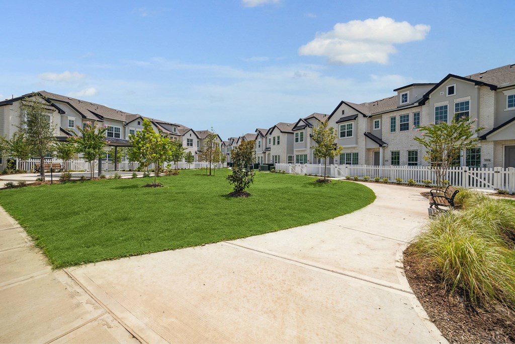 A residential area with houses and a green lawn.