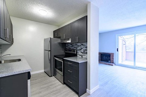 a kitchen with a stove and a refrigerator