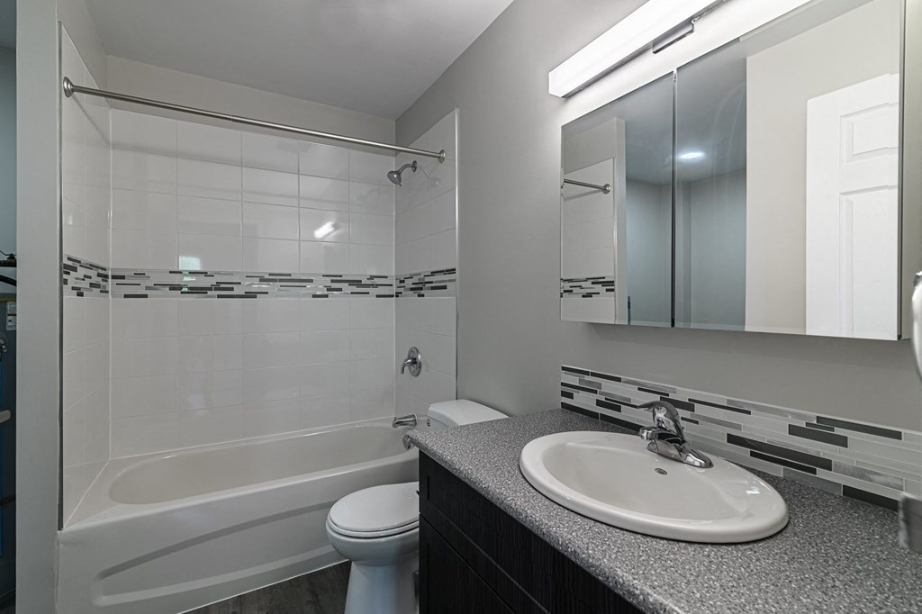 a bathroom with a sink toilet and bathtub