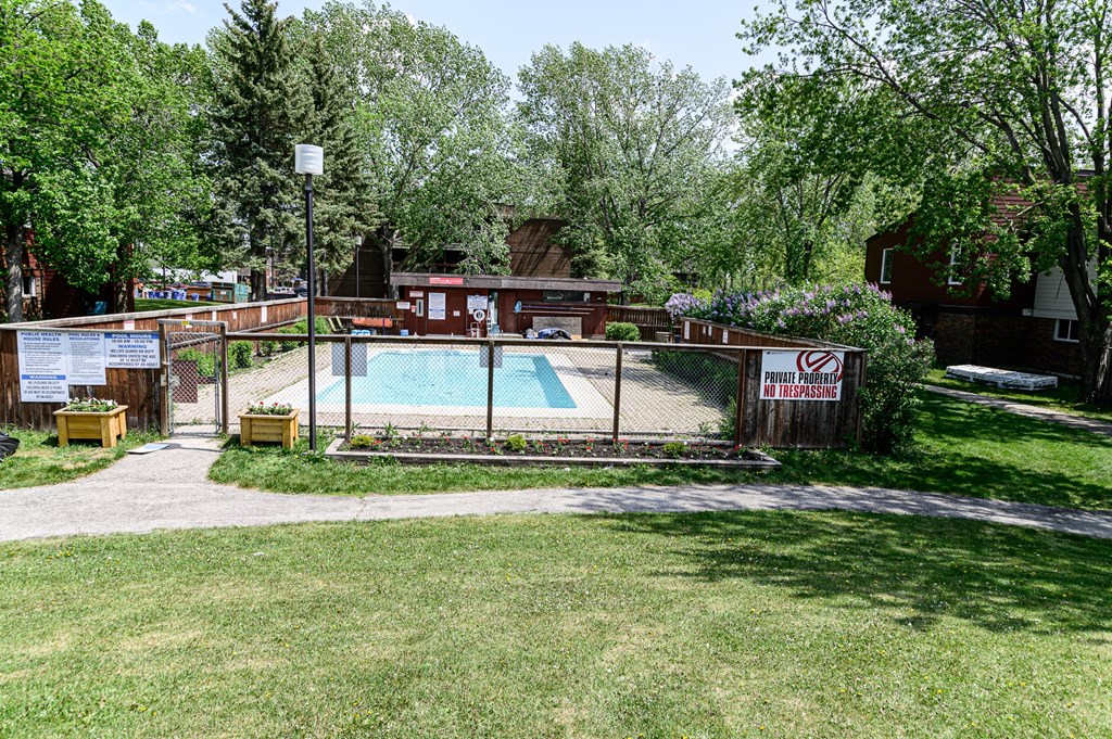 a view of the pool from the grassy area