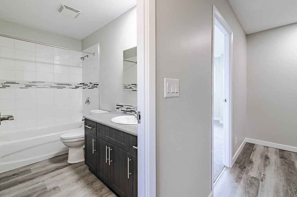 an empty bathroom with a toilet and a sink and a shower