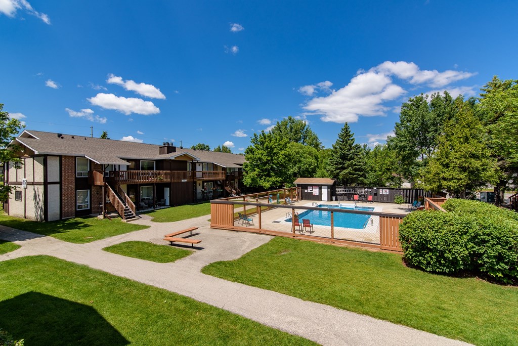 a backyard with a pool and a house with a swimming pool