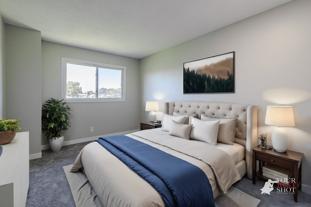 a bedroom with a large bed and a window