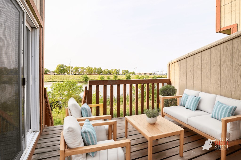 a balcony with a couch and a table