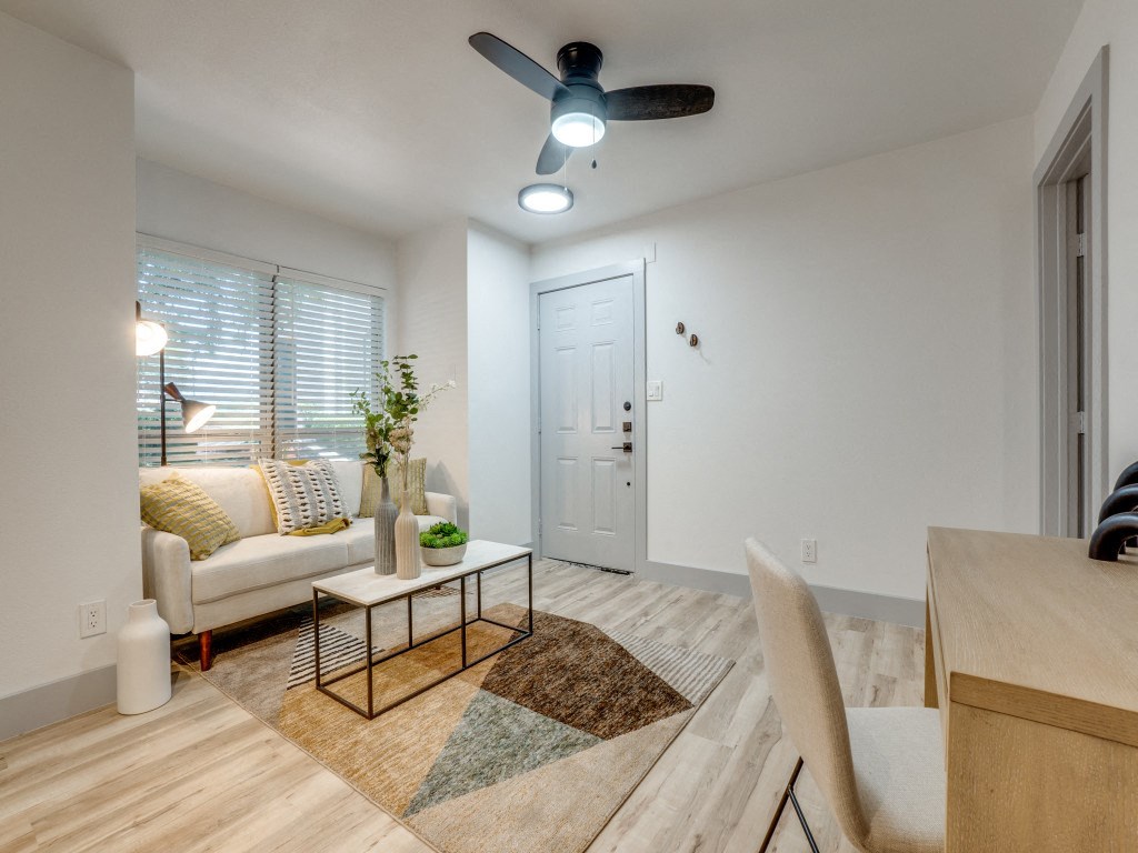 a living room with a couch and a ceiling fan