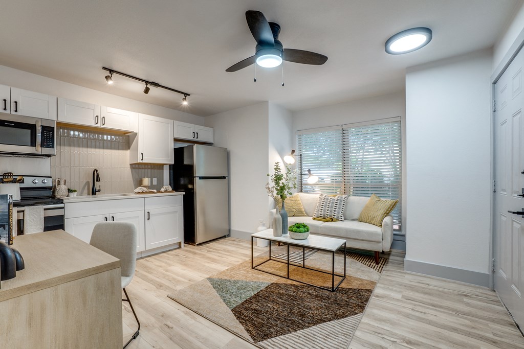 a living room and kitchen with a couch and a table