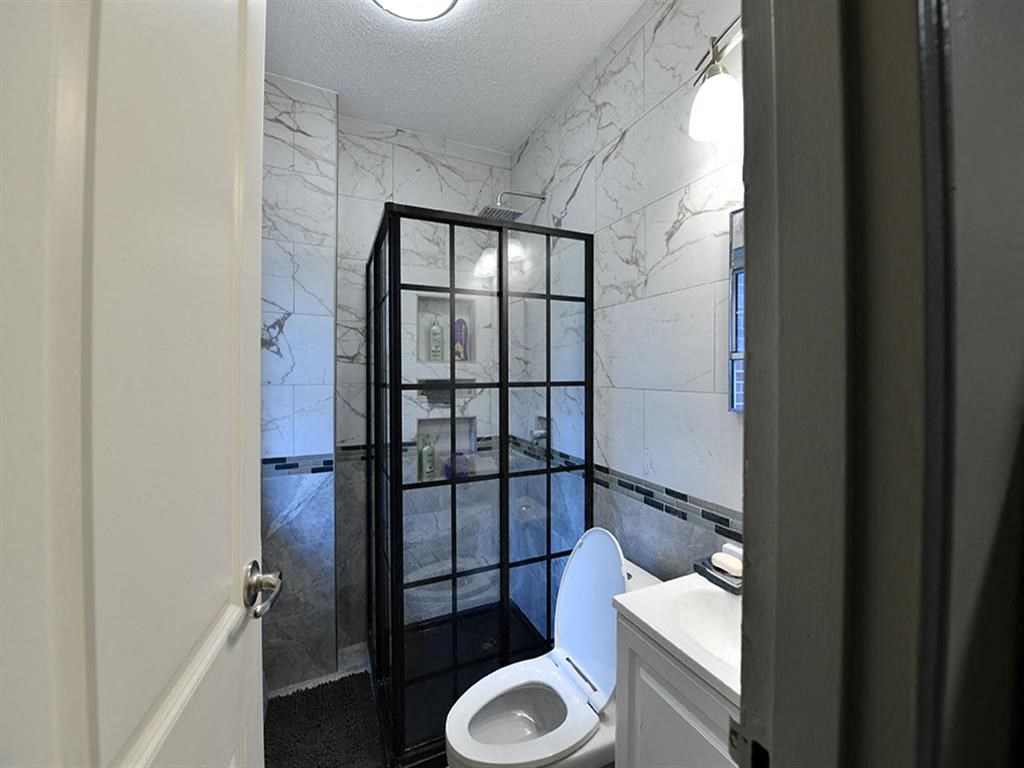 a bathroom with a toilet and a glass shower