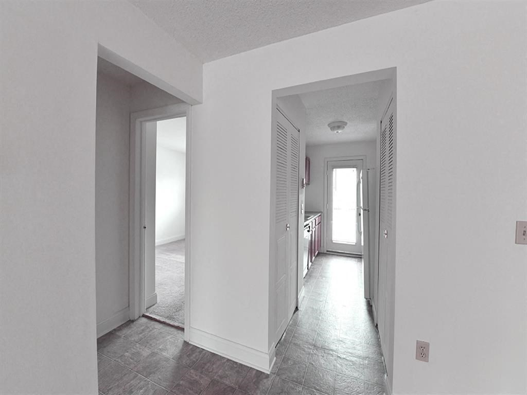 View of Renovated apartment with white alls and grey flooring Apartment at Silvertree Apartments