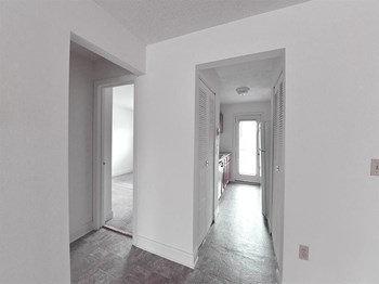 View of Renovated apartment with white alls and grey flooring Apartment at Silvertree Apartments - Photo Gallery 8