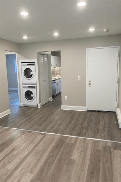 View of Renovated Apartment at Silvertree Apartments showing grey plank-style flooring and built-in washer and drying in unit.