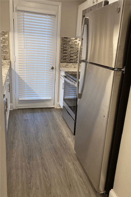 a kitchen with a refrigerator and a door
