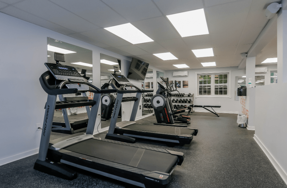 a gym with treadmills and other exercise equipment in a building