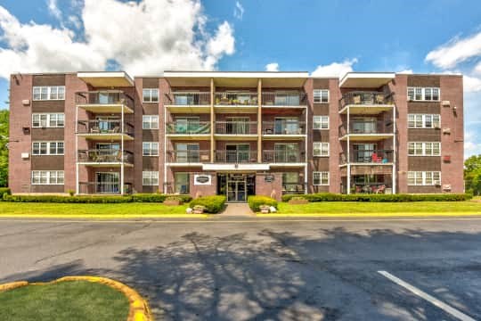a large apartment building on the side of a street