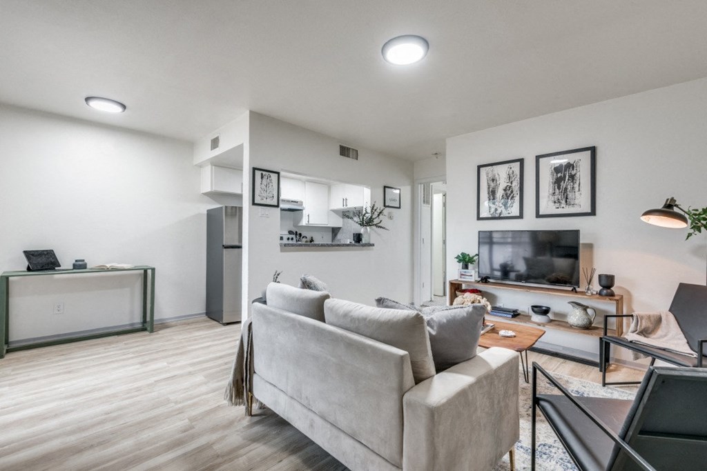 a living room with white walls and hardwood floors