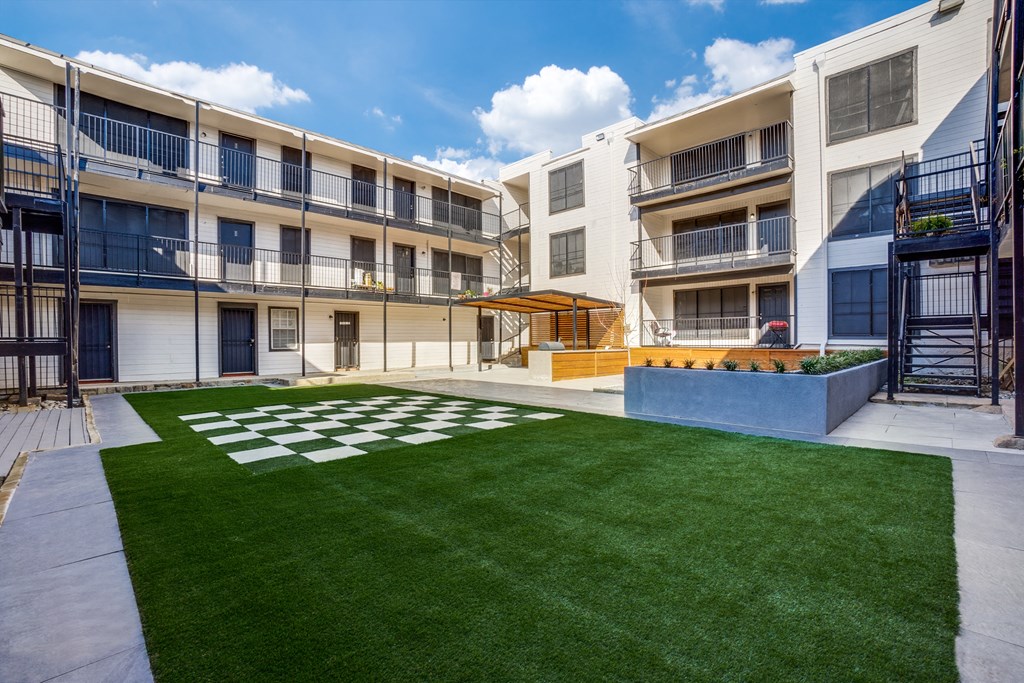 our apartments have an open courtyard with grass and a fire pit