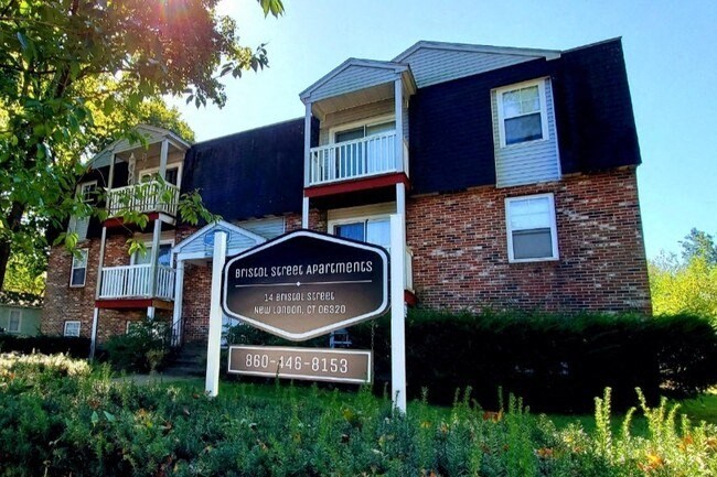 an apartment building with a sign in front of it