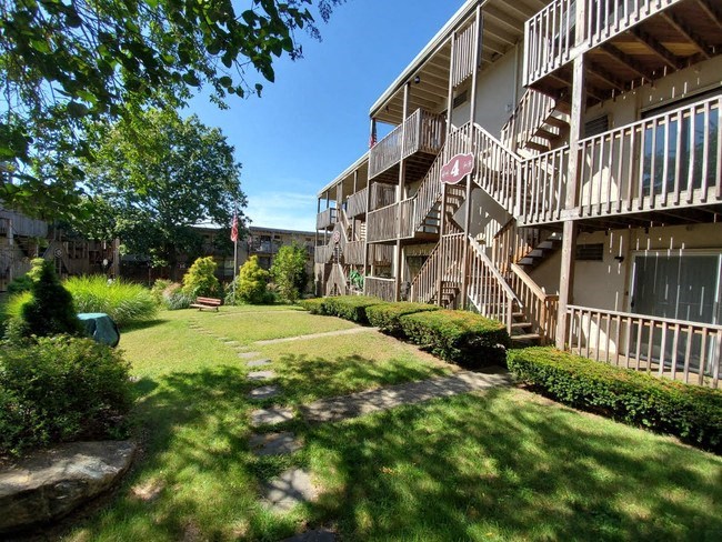 the backyard of an apartment building with a yard and stairs