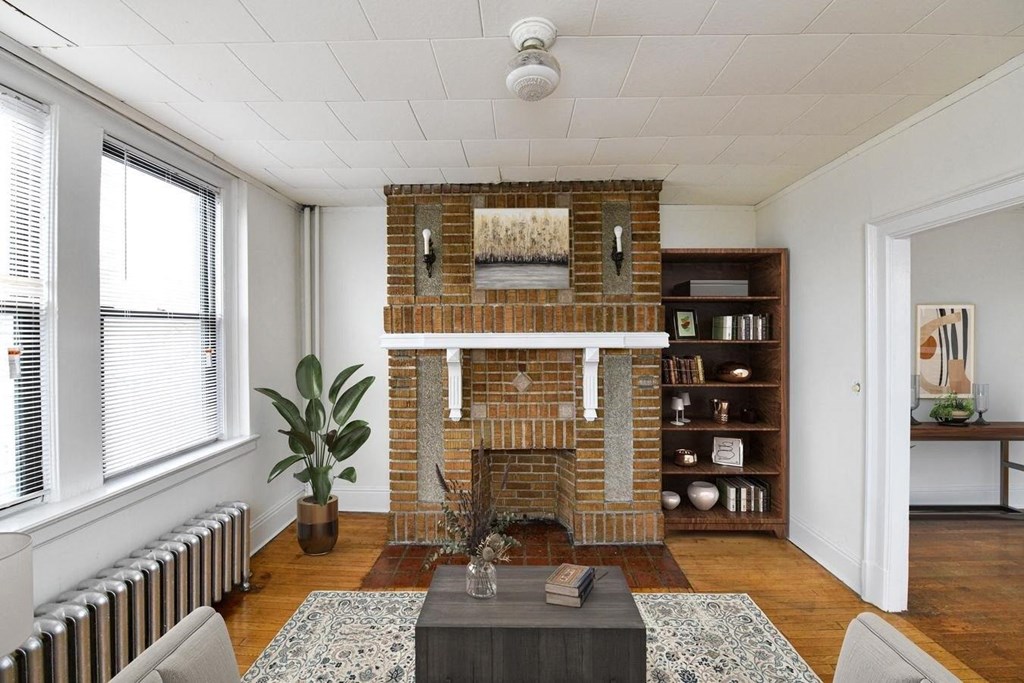 the living room has a brick fireplace and a coffee table