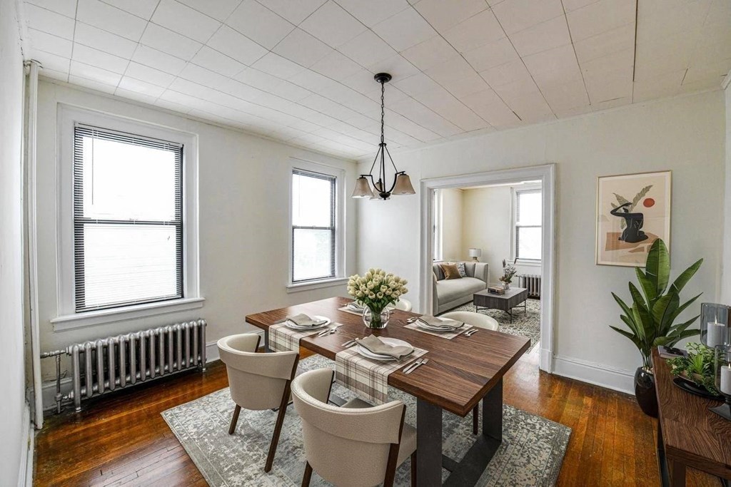 a dining room with a wooden table and chairs