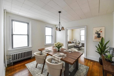a dining room with a wooden table and chairs