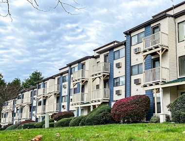 Exterior View of Silvertree Apartments showing private2-story and 3-story balconies and green space