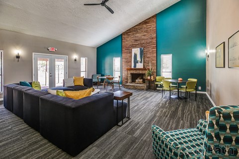 a living room with a couch and chairs and a fireplace
