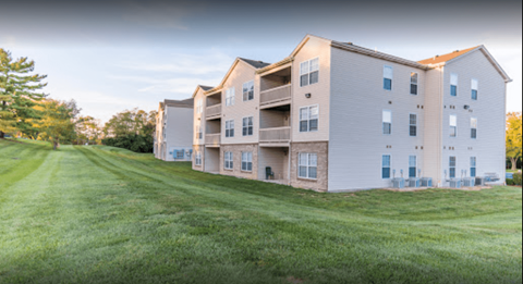 A large apartment complex with multiple buildings and green lawns.