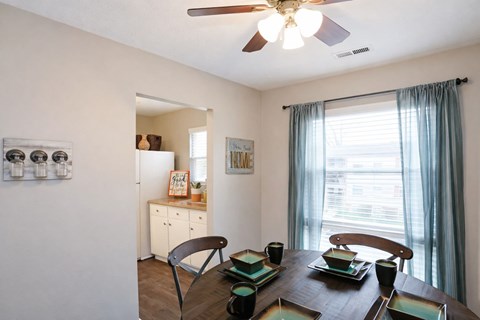 A dining room with a table set for two.