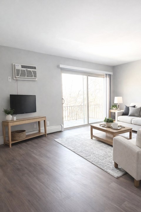 A living room with a flat screen TV mounted on the wall.