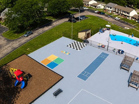 A playground with a blue surface and a checkered pattern.