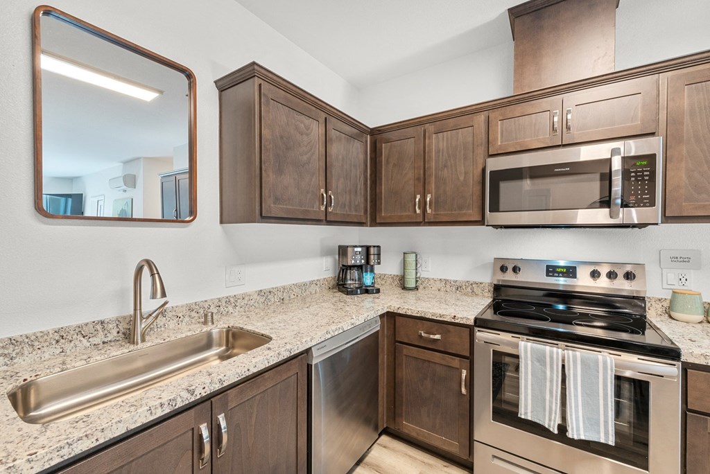 granite countertops and stainless steel appliances in modern kitchen