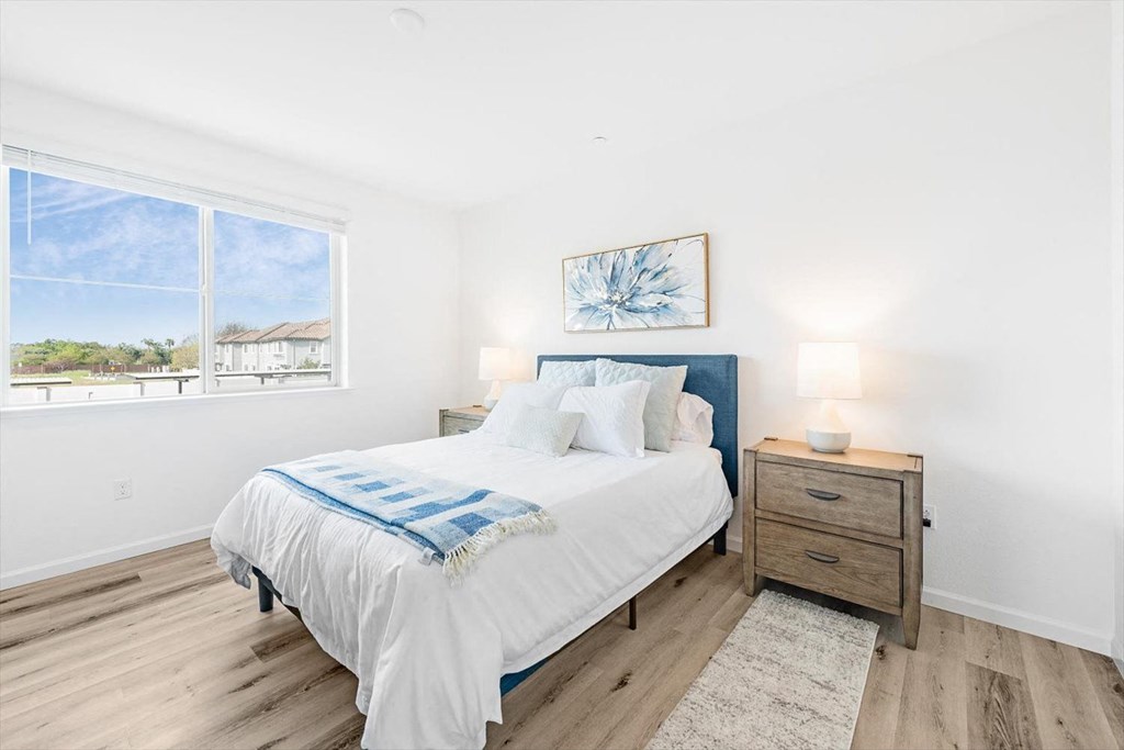 a bedroom with a bed and a window