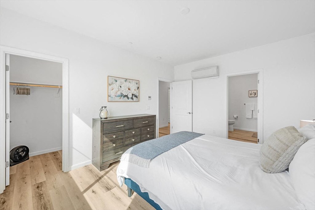 a bedroom with a bed and a dresser