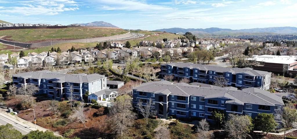 an aerial view of a neighborhood with houses and a train track