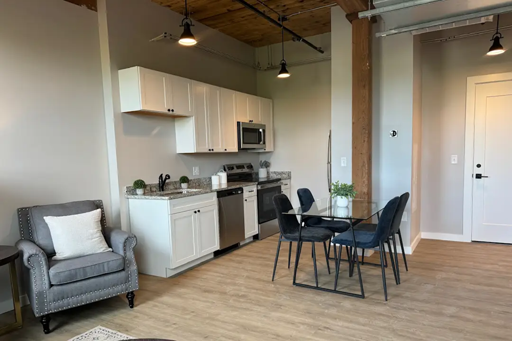 a kitchen and dining area with a table and chairs