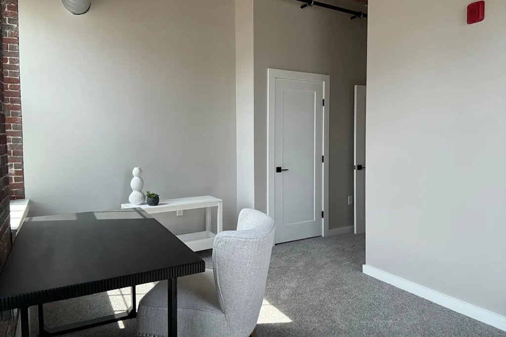 a dining room with a table and chairs and a door