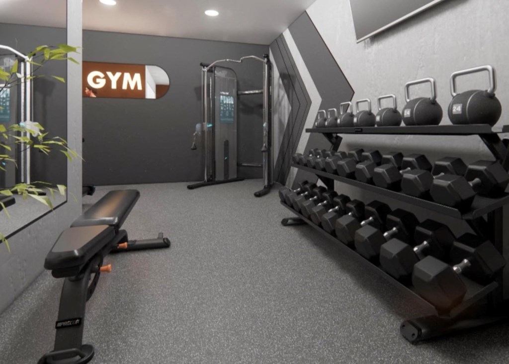 a gym with weights on a rack and a chair