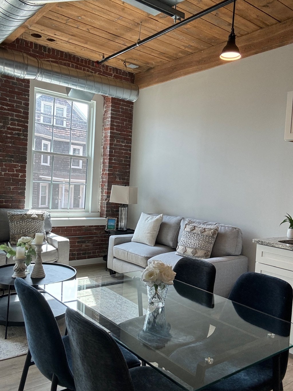 a living room with a glass table and a couch