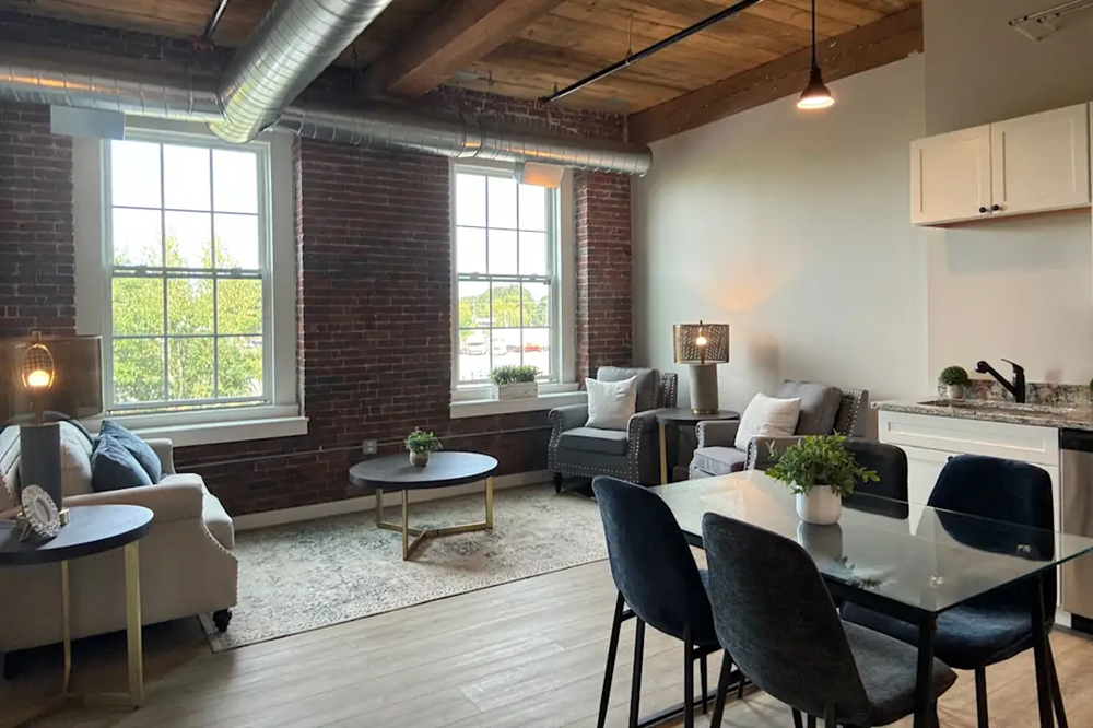 an open living room with a dining room table and a couch