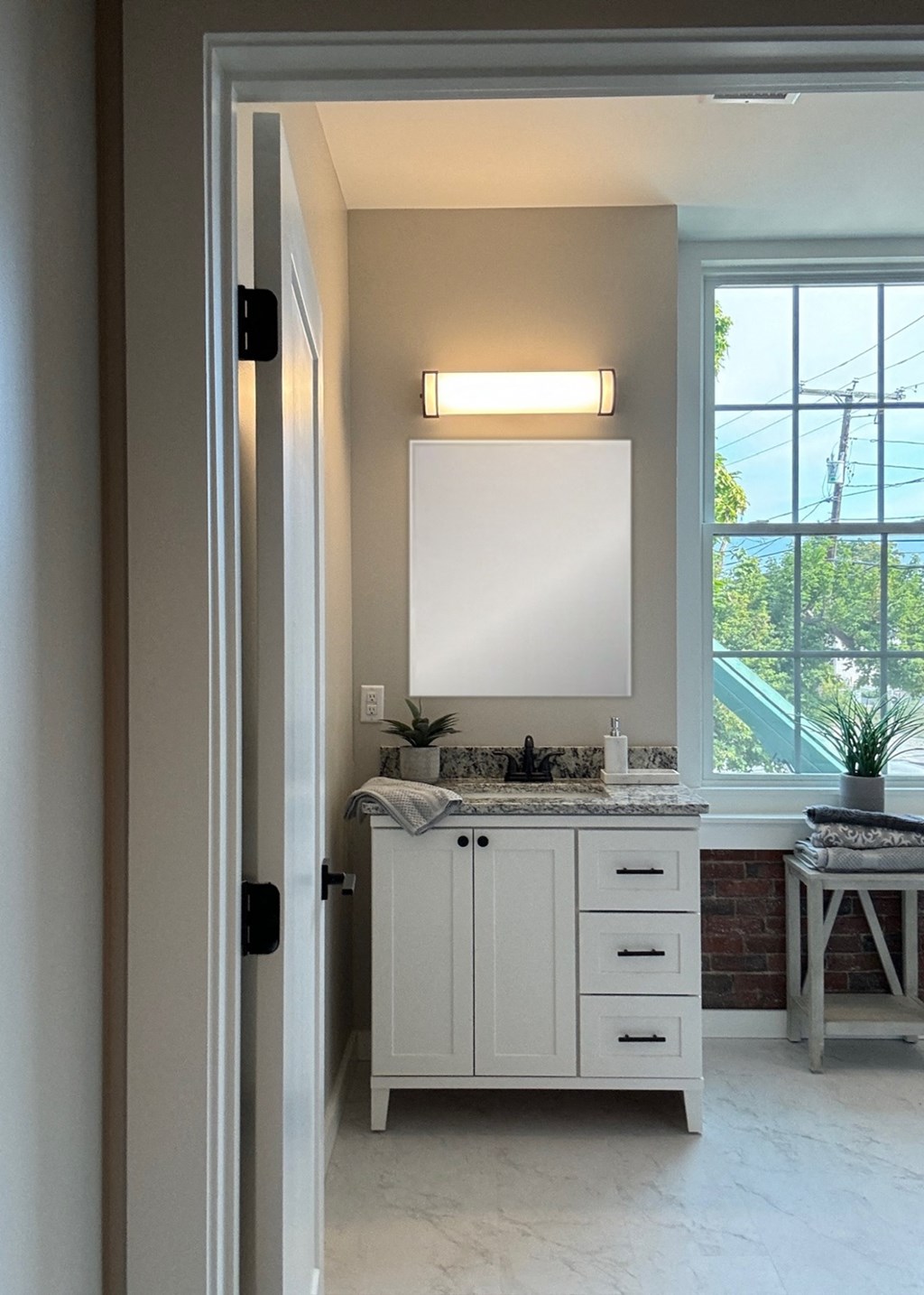 a bathroom with a sink and a mirror and a window