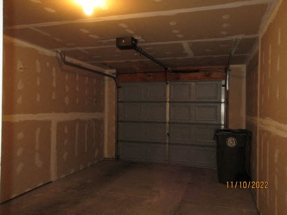 a empty garage with a garbage can in it