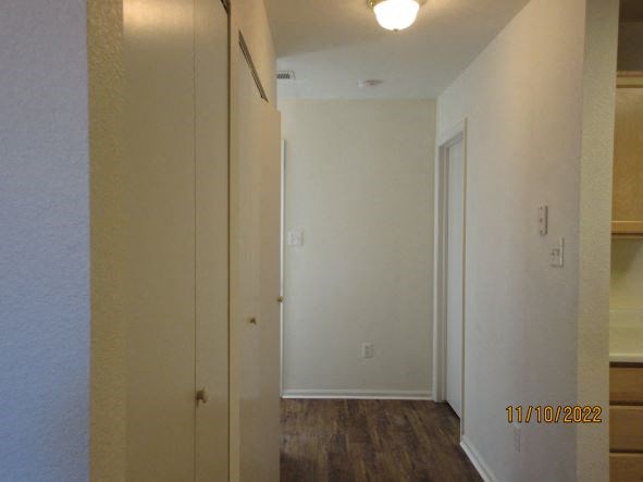 a hallway with a white closet and a door