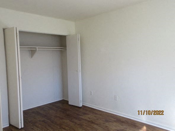 an empty room with white walls and a closet