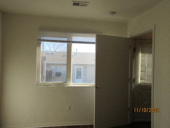 an empty room with a window and a door