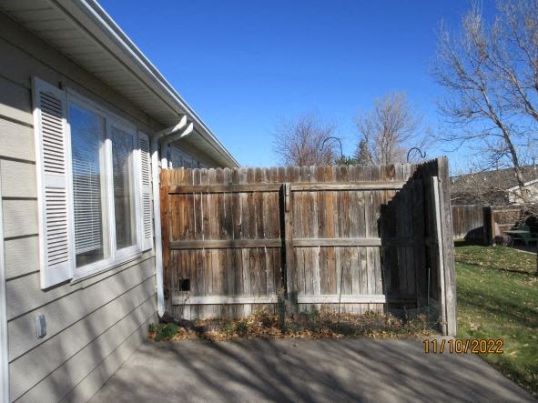 a wooden fence in front of a house