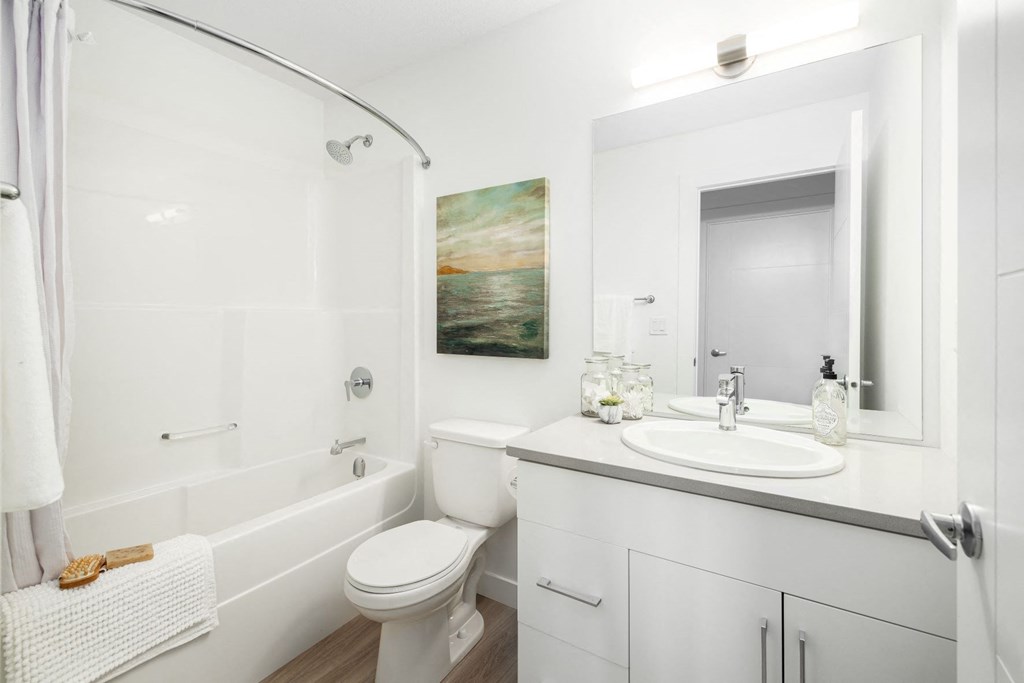 a bathroom with a sink toilet and a bath tub