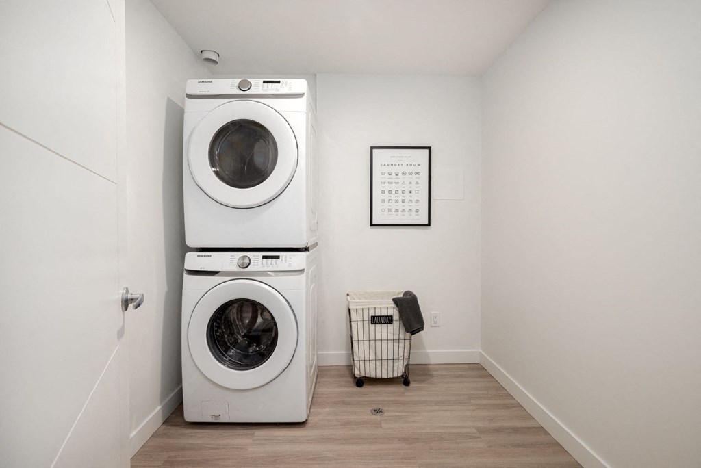 a white washer and dryer in a room with a washing machine