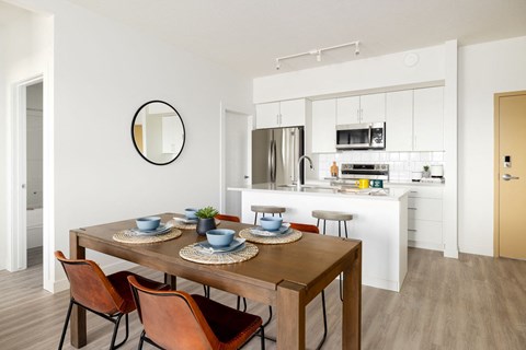 an open kitchen and dining room with a table and chairs