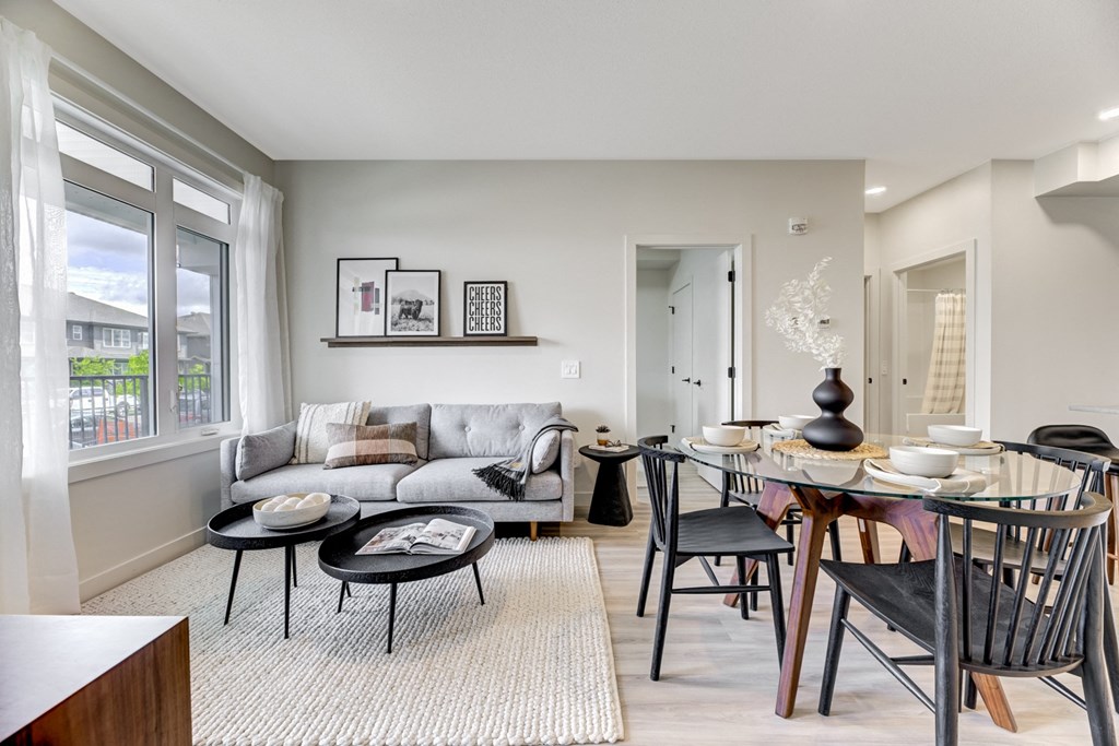 a living room and dining room with a table and chairs and a couch