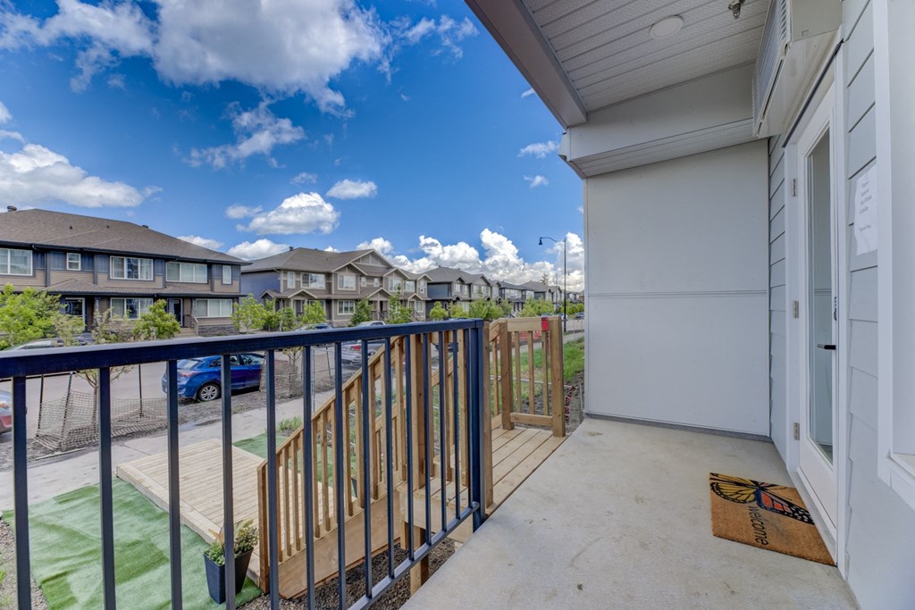 the view from the balcony of an apartment building with a blue sky